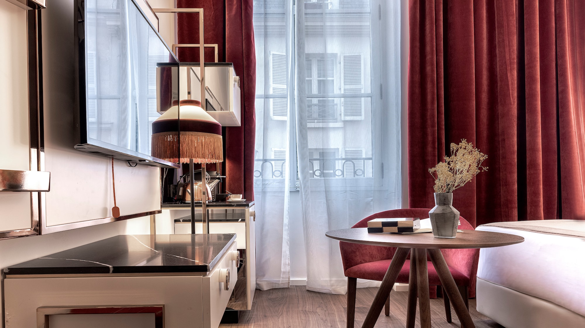 a room with a table and chairs and a television