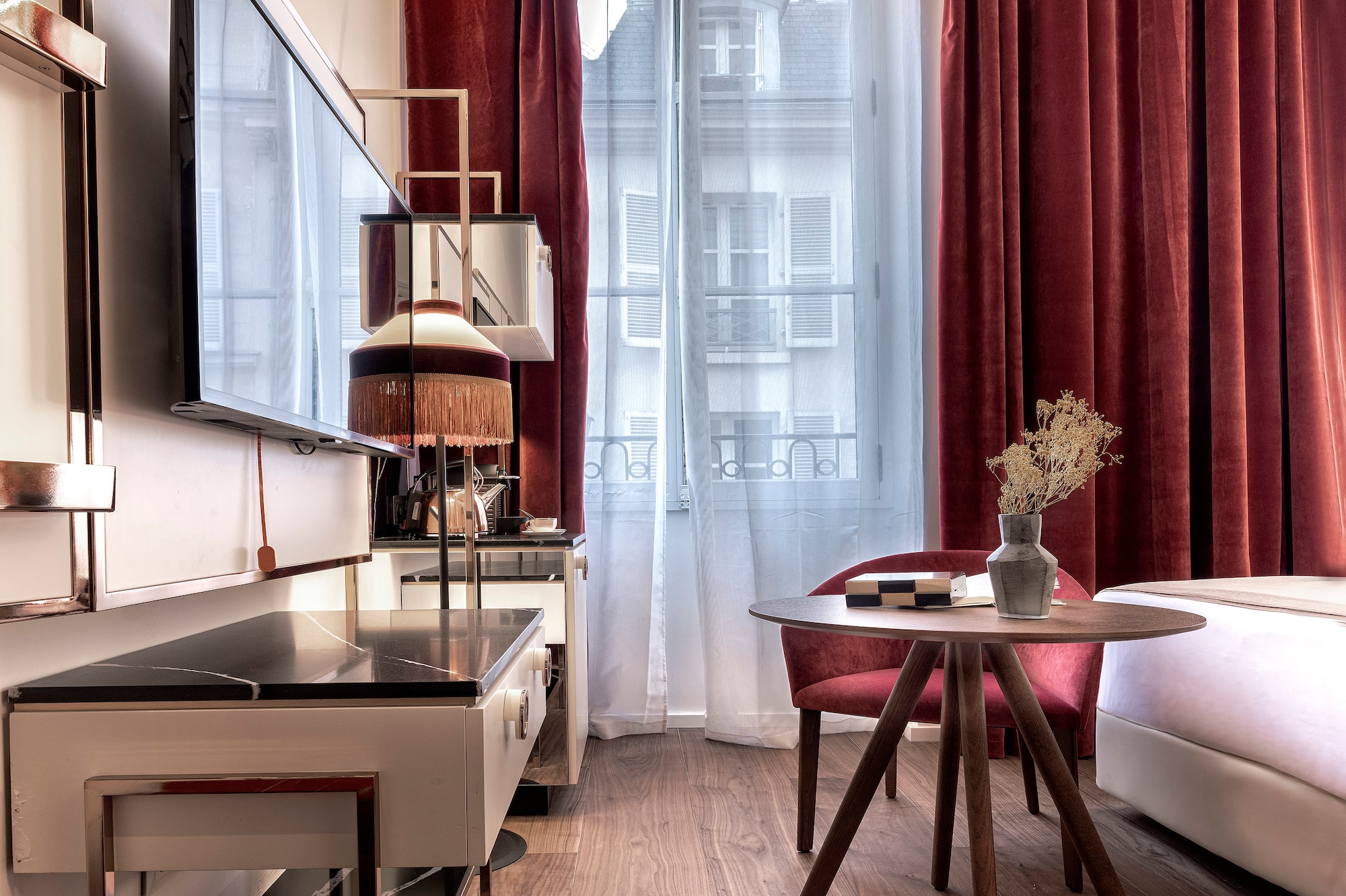 a room with a table and chairs and a television