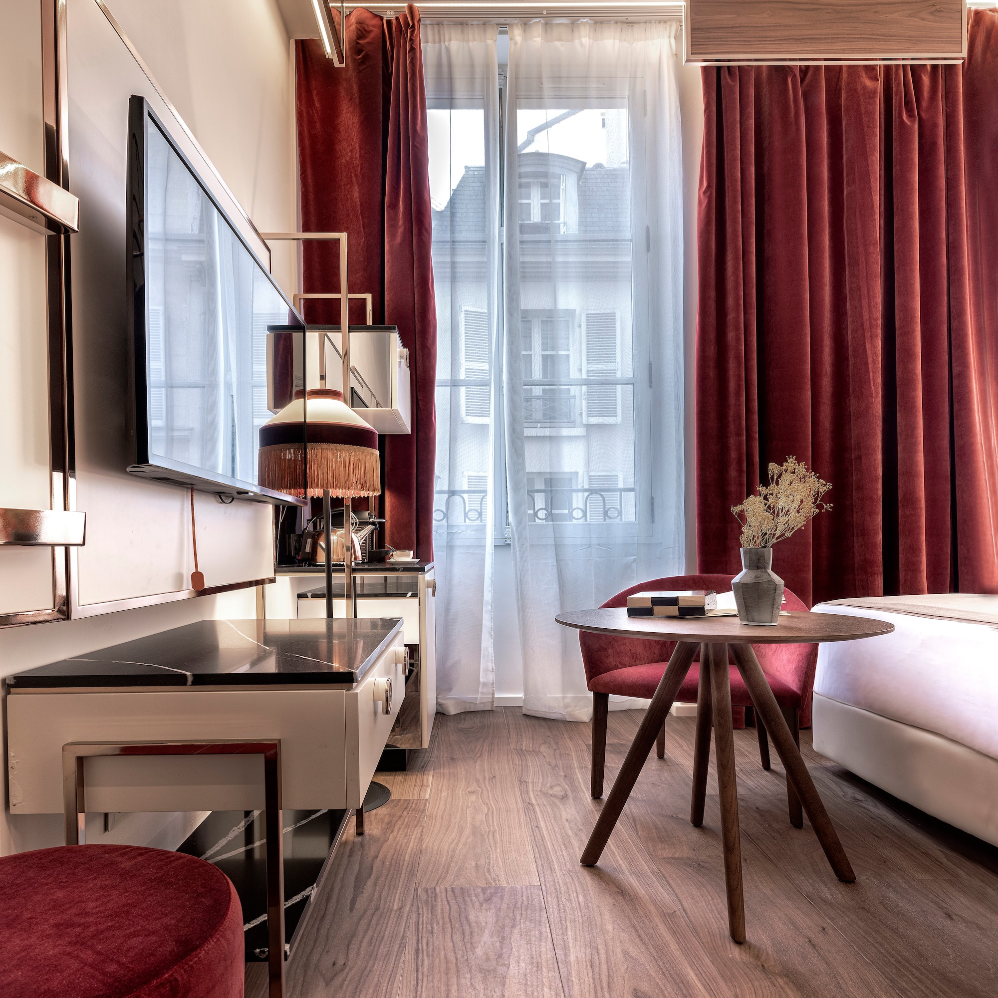 a room with a table and chairs and a television