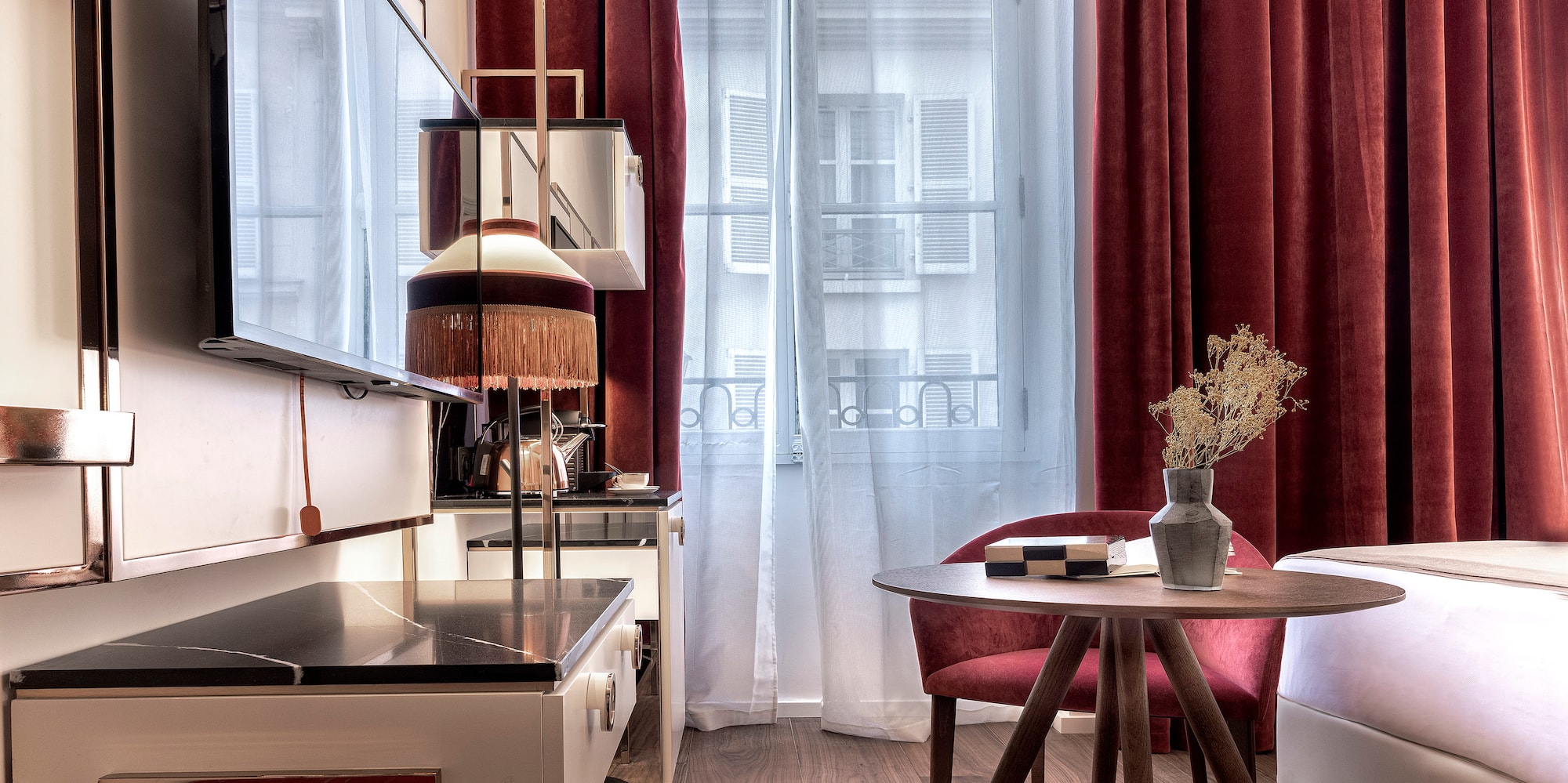 a room with a table and chairs and a television