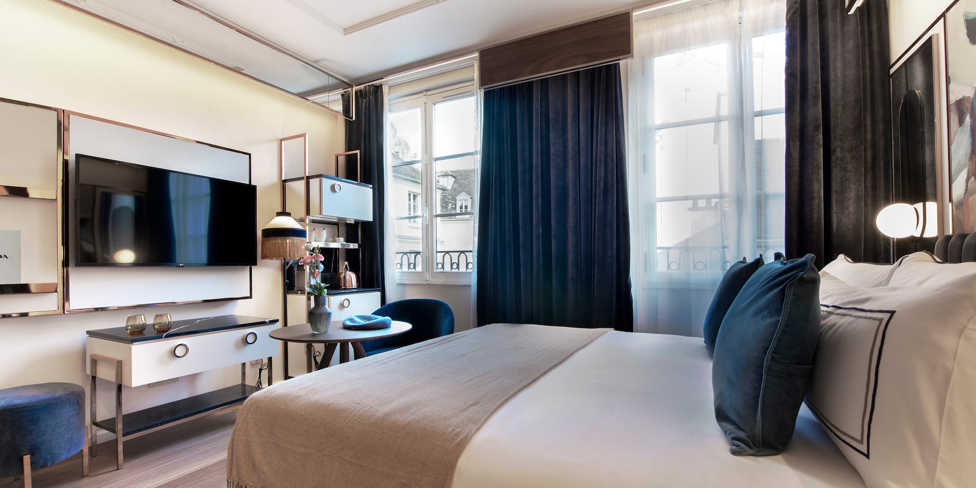 a bedroom with a large bed and a tv