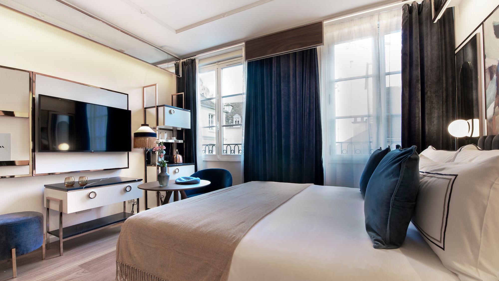 a bedroom with a large bed and a tv