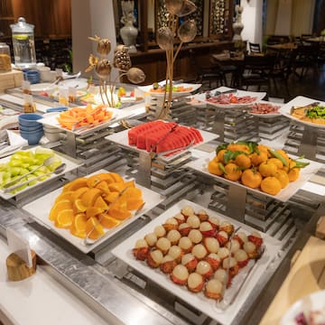 a buffet table with plates of fruit and vegetables