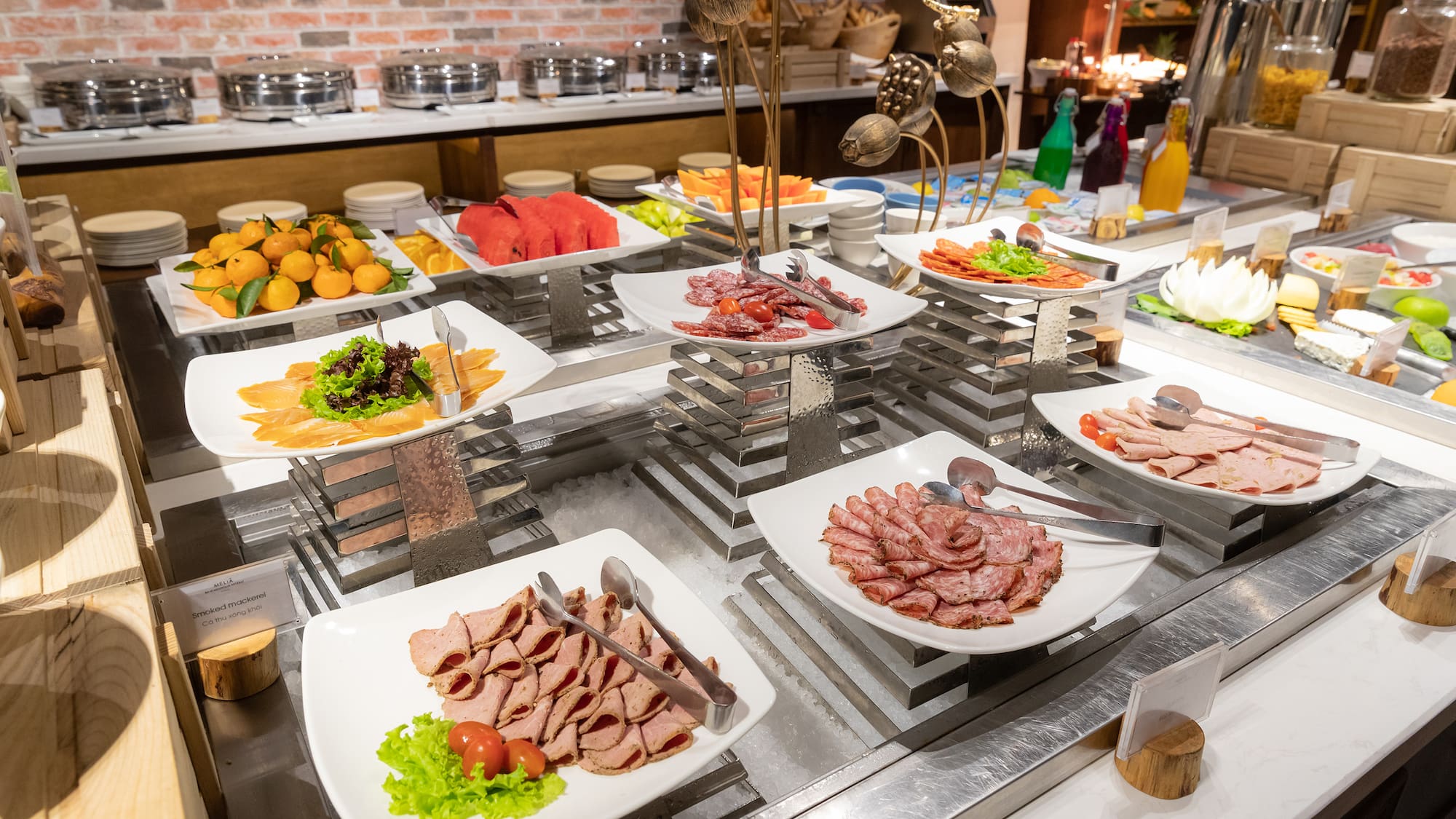 a buffet table with plates of food