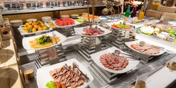 a buffet table with plates of food