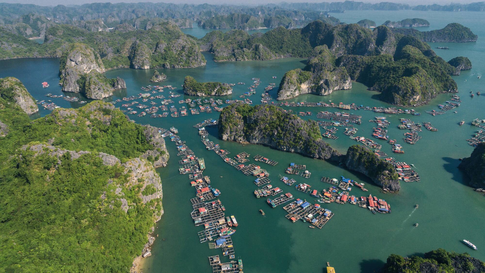 aerial view of a body of water with boats and islands