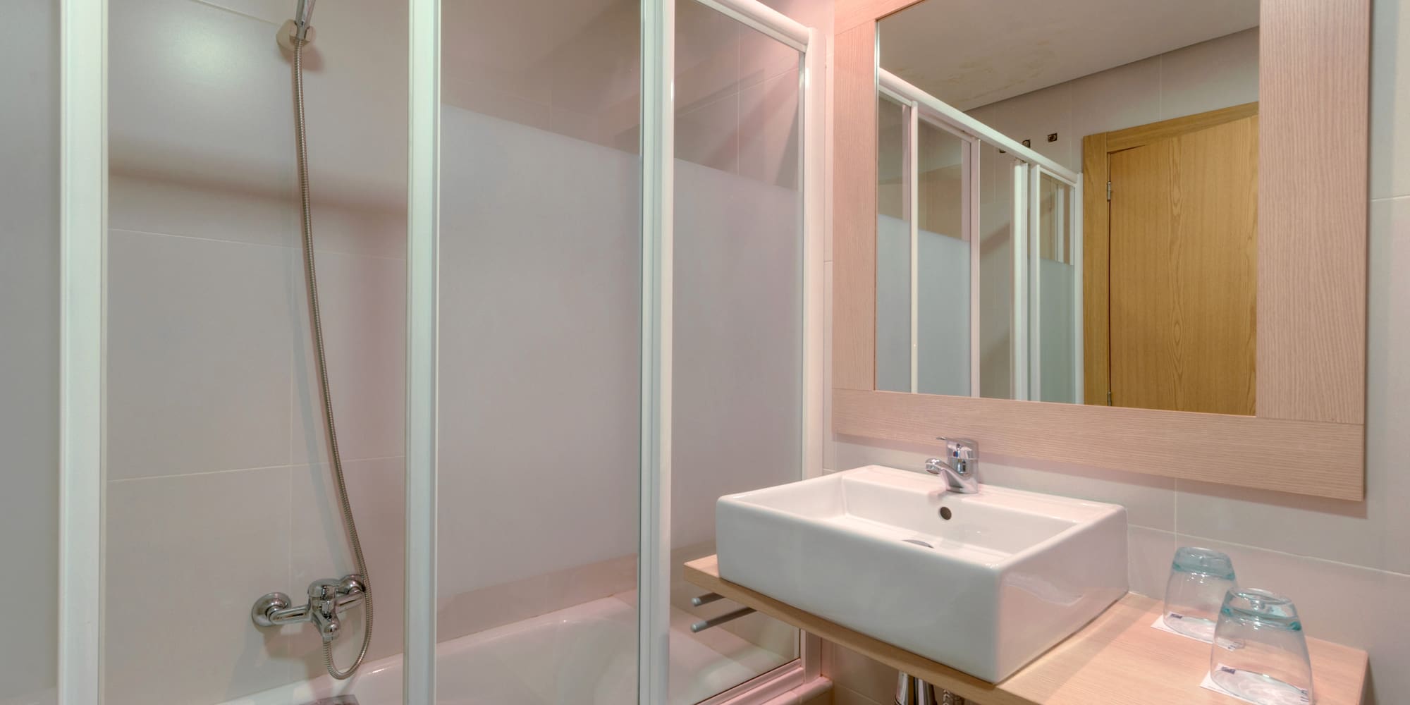 a bathroom with a shower and sink