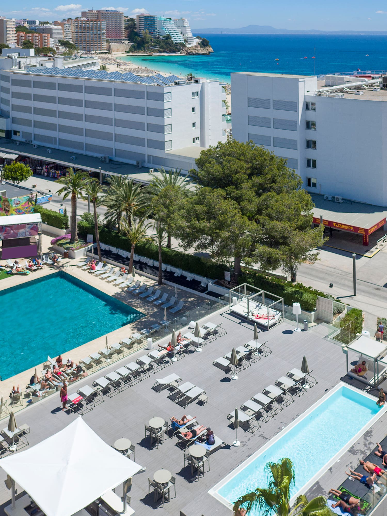 a swimming pool and buildings by the water