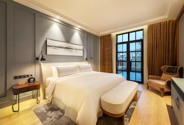 a bedroom with a bed and a chair