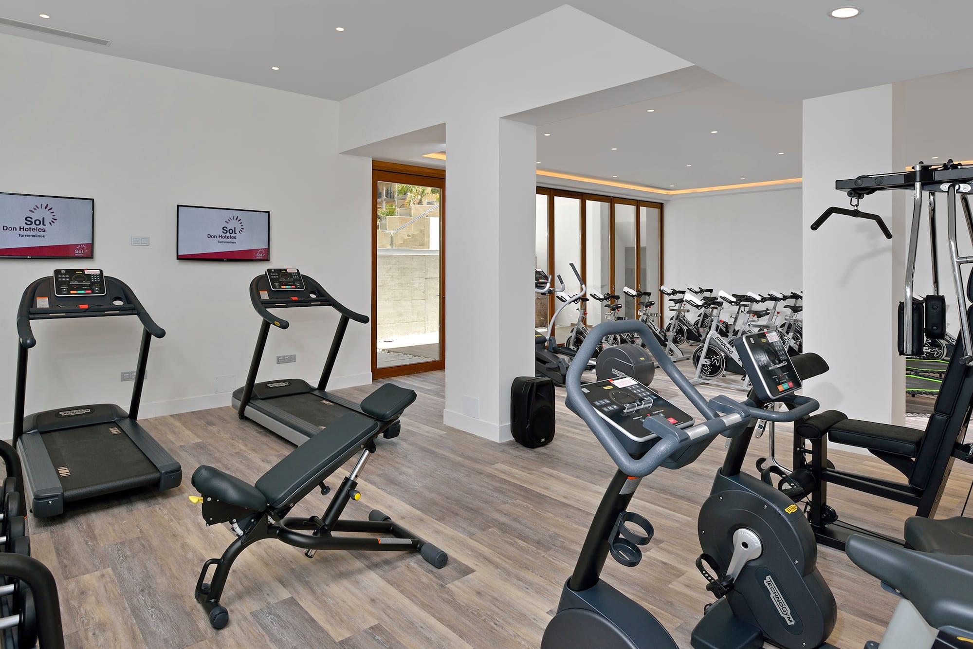 a room with exercise equipment and a television