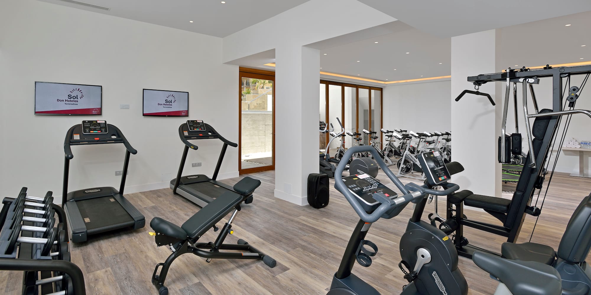 a room with exercise equipment and a television