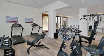 a room with exercise equipment and a television