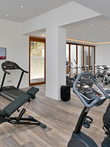 a room with exercise equipment and a television