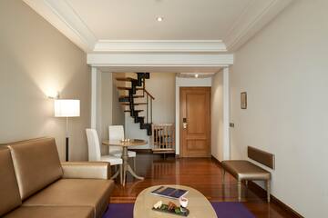 a living room with a spiral staircase and a couch