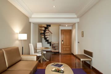 a living room with a spiral staircase and a couch