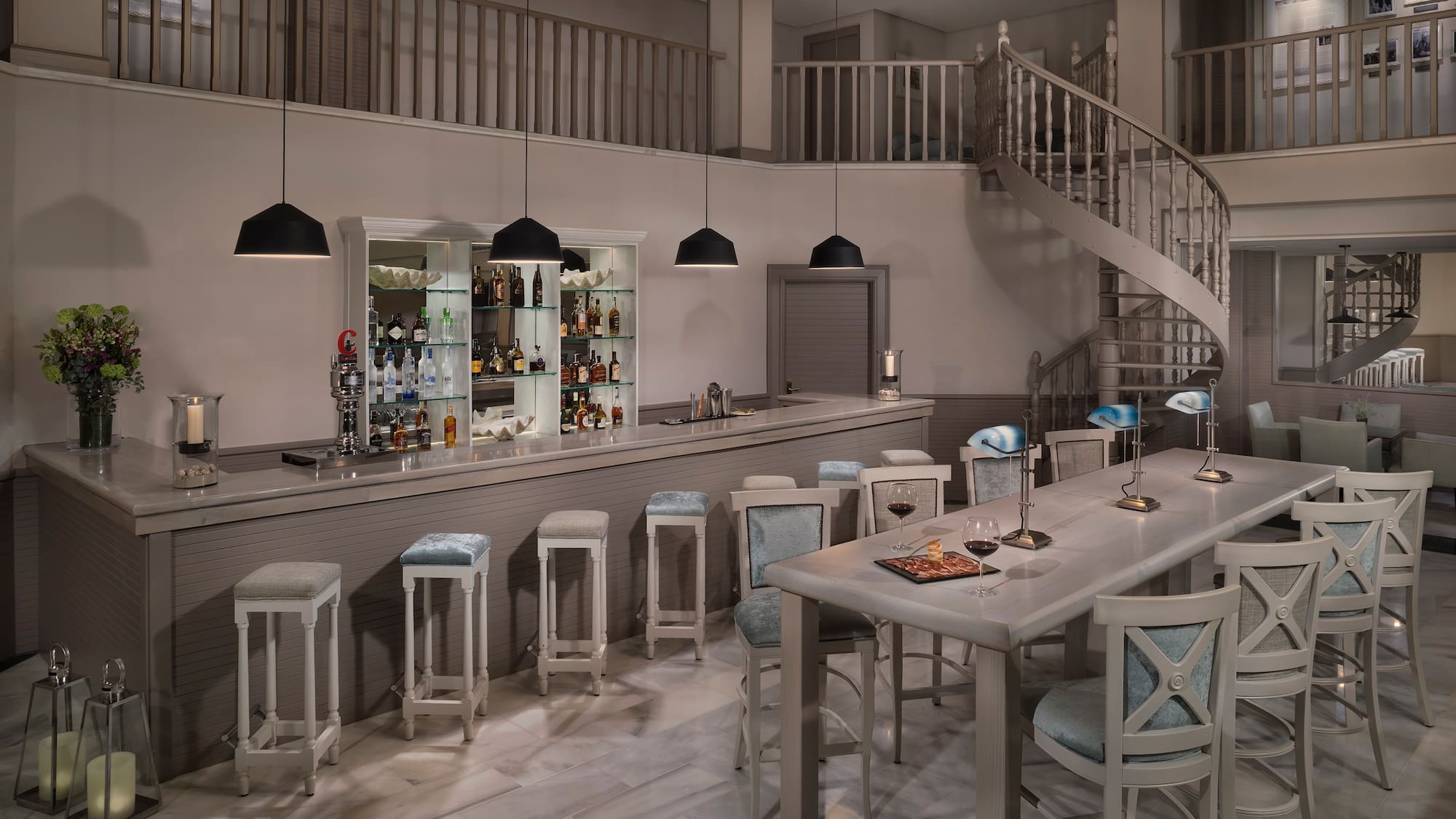 a room with a spiral staircase and a bar