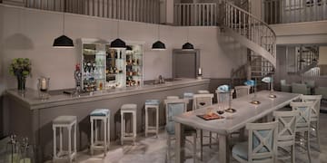 a room with a spiral staircase and a bar