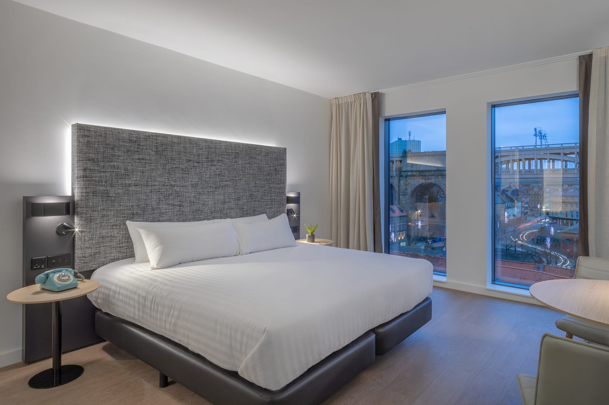 a bed in a room with windows