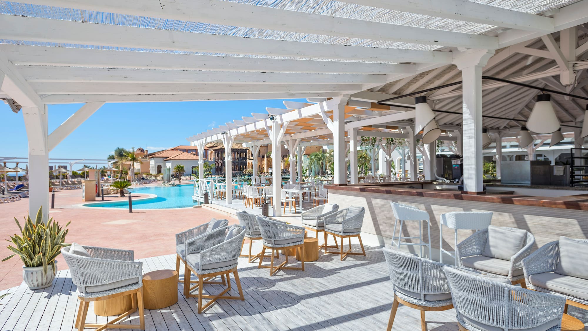 a pool with chairs and tables