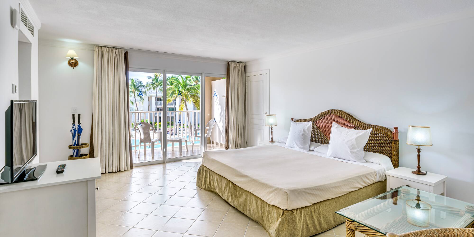 a bedroom with a glass table and a bed