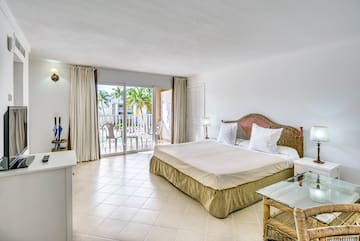 a bedroom with a glass table and a bed