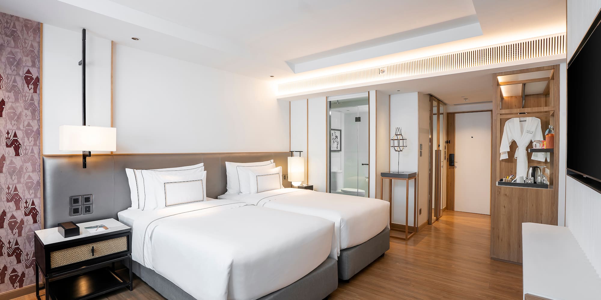 a room with two beds and a wood floor