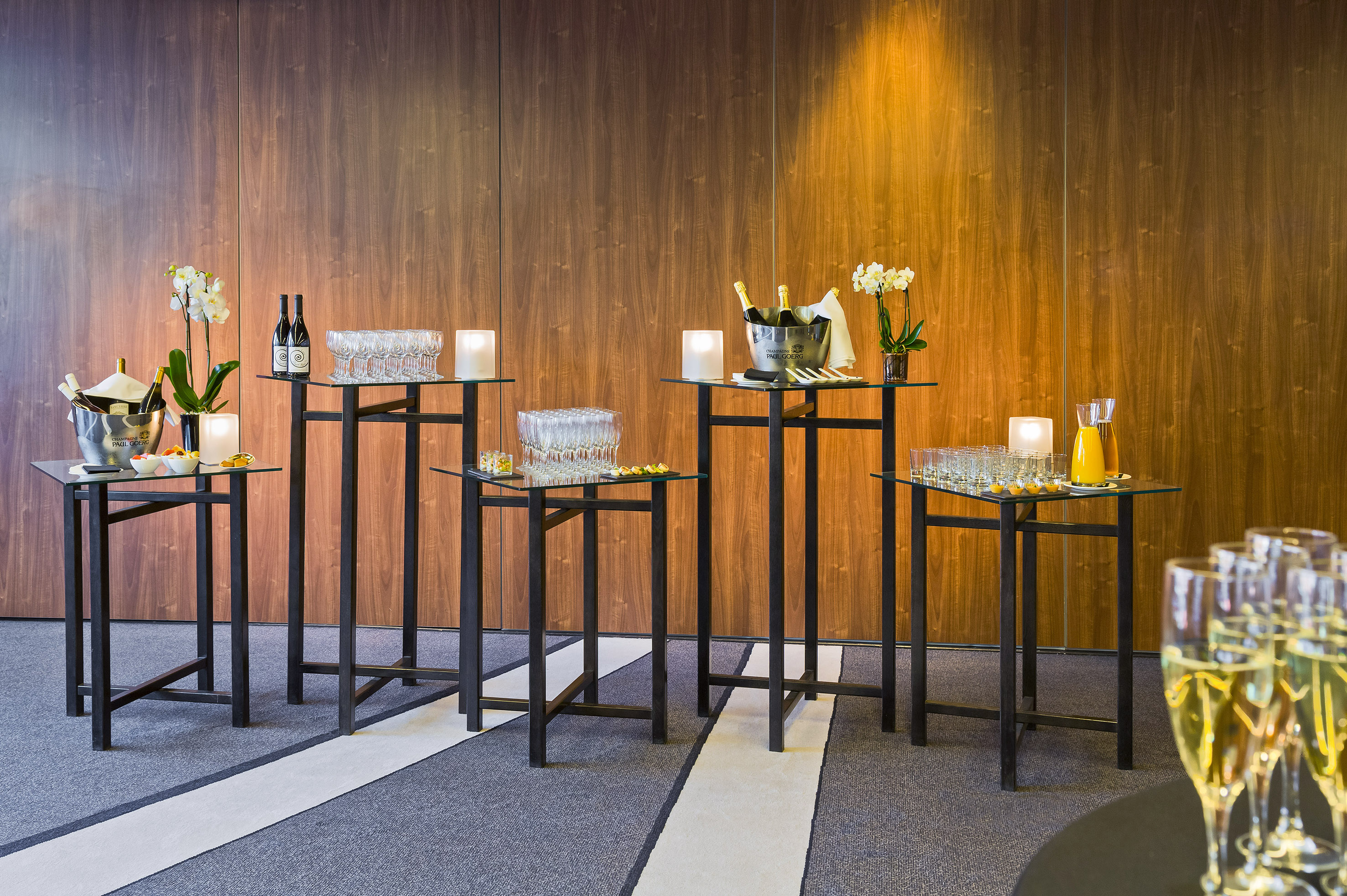 Event cocktail bar setup with champagne, drinks, and appetizers.