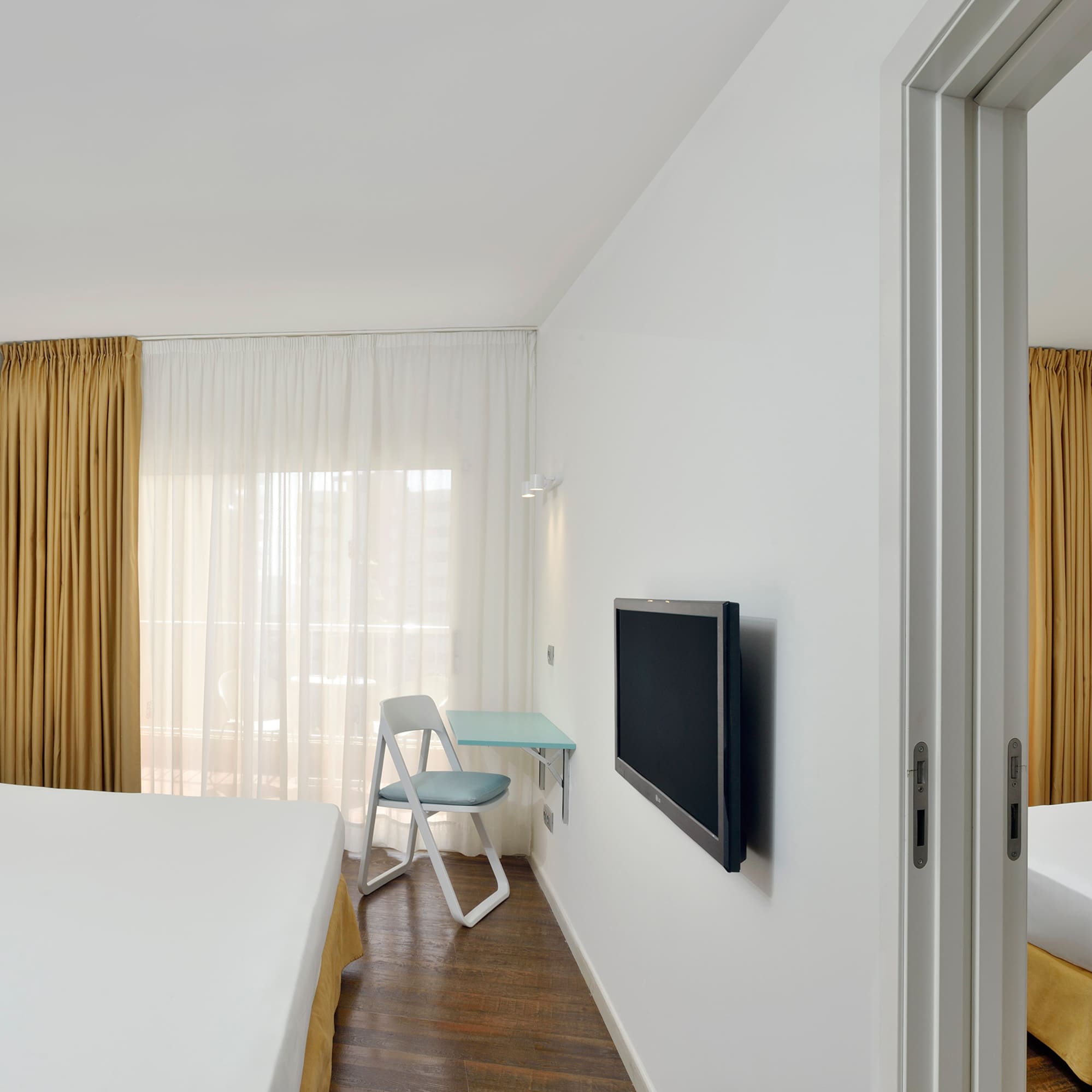 a room with a bed and a tv