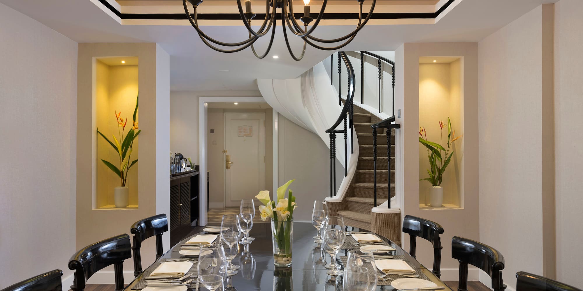 a dining table with glasses and plates
