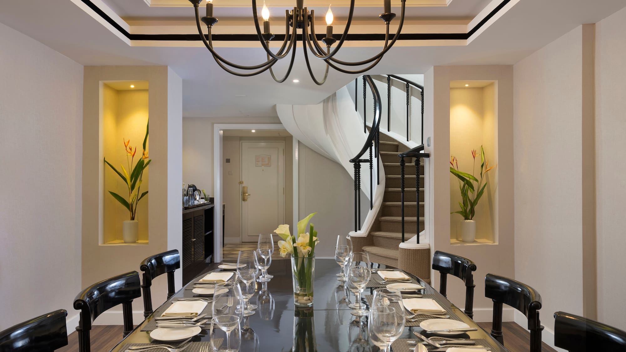 a dining table with glasses and plates