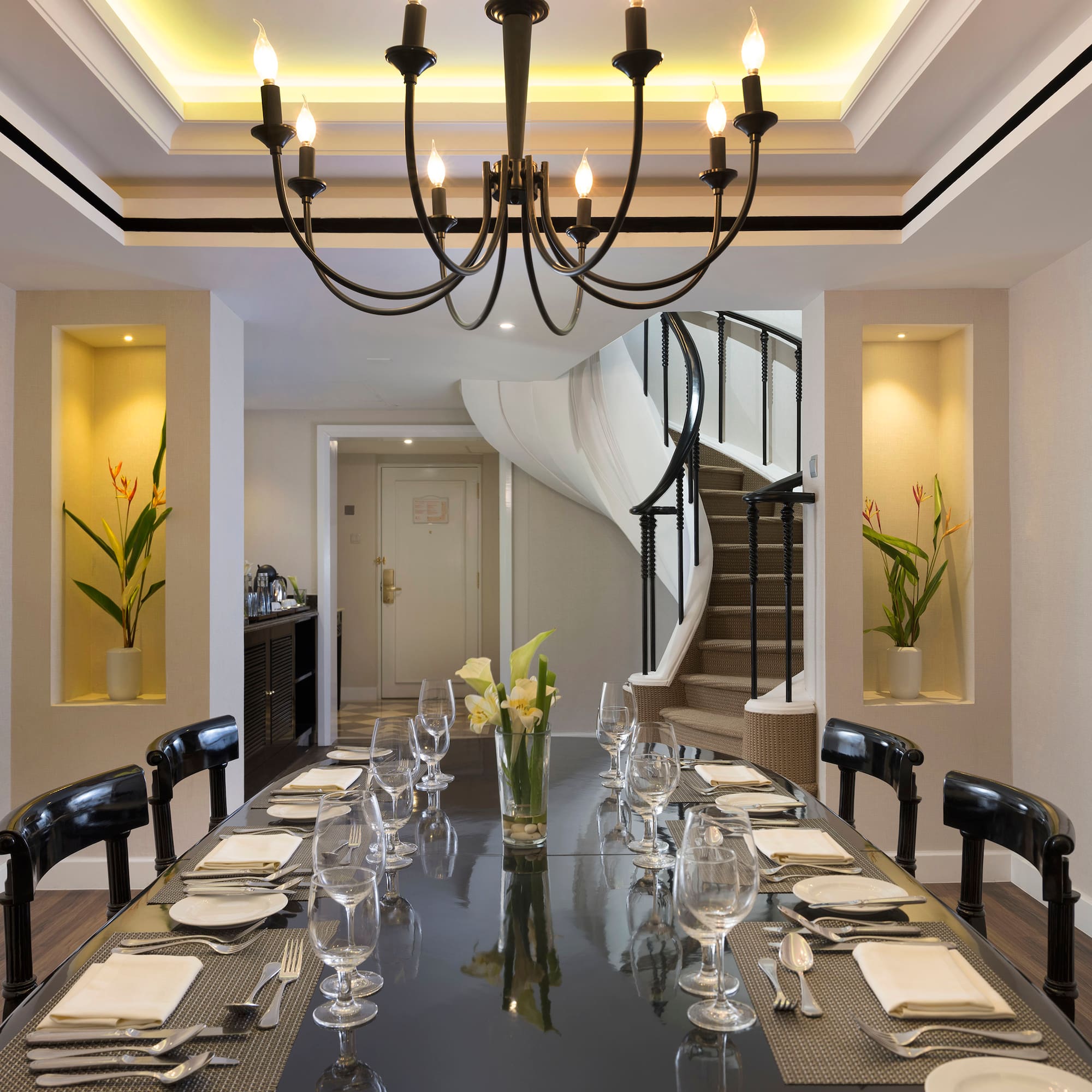 a dining table with glasses and plates