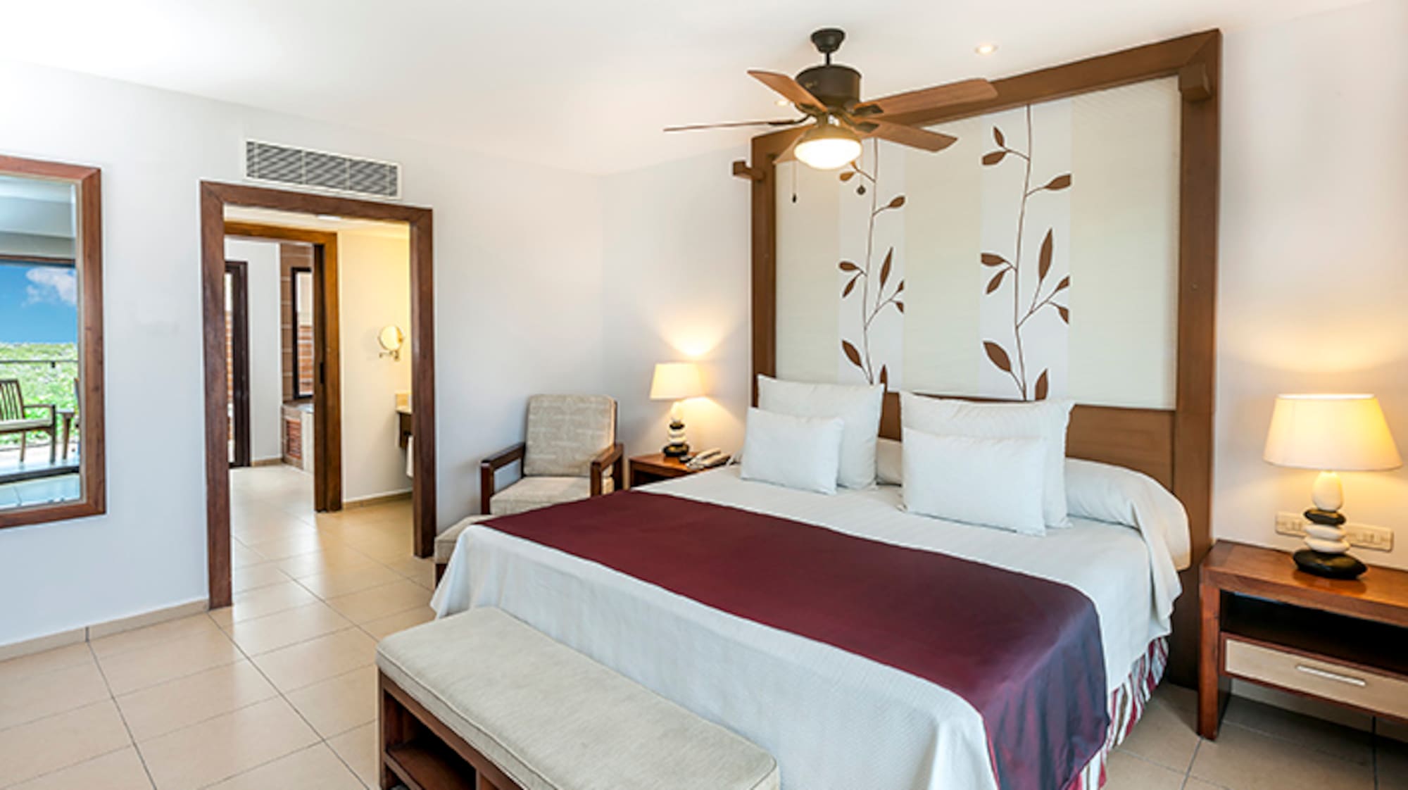 a bedroom with a bed and a fan