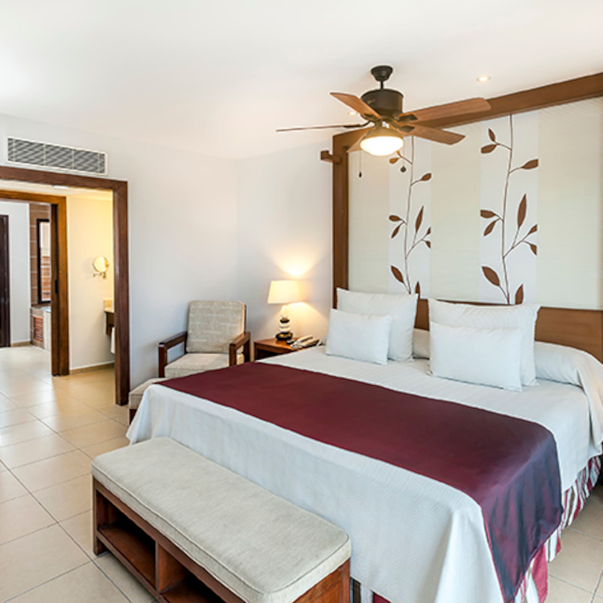 a bedroom with a bed and a fan