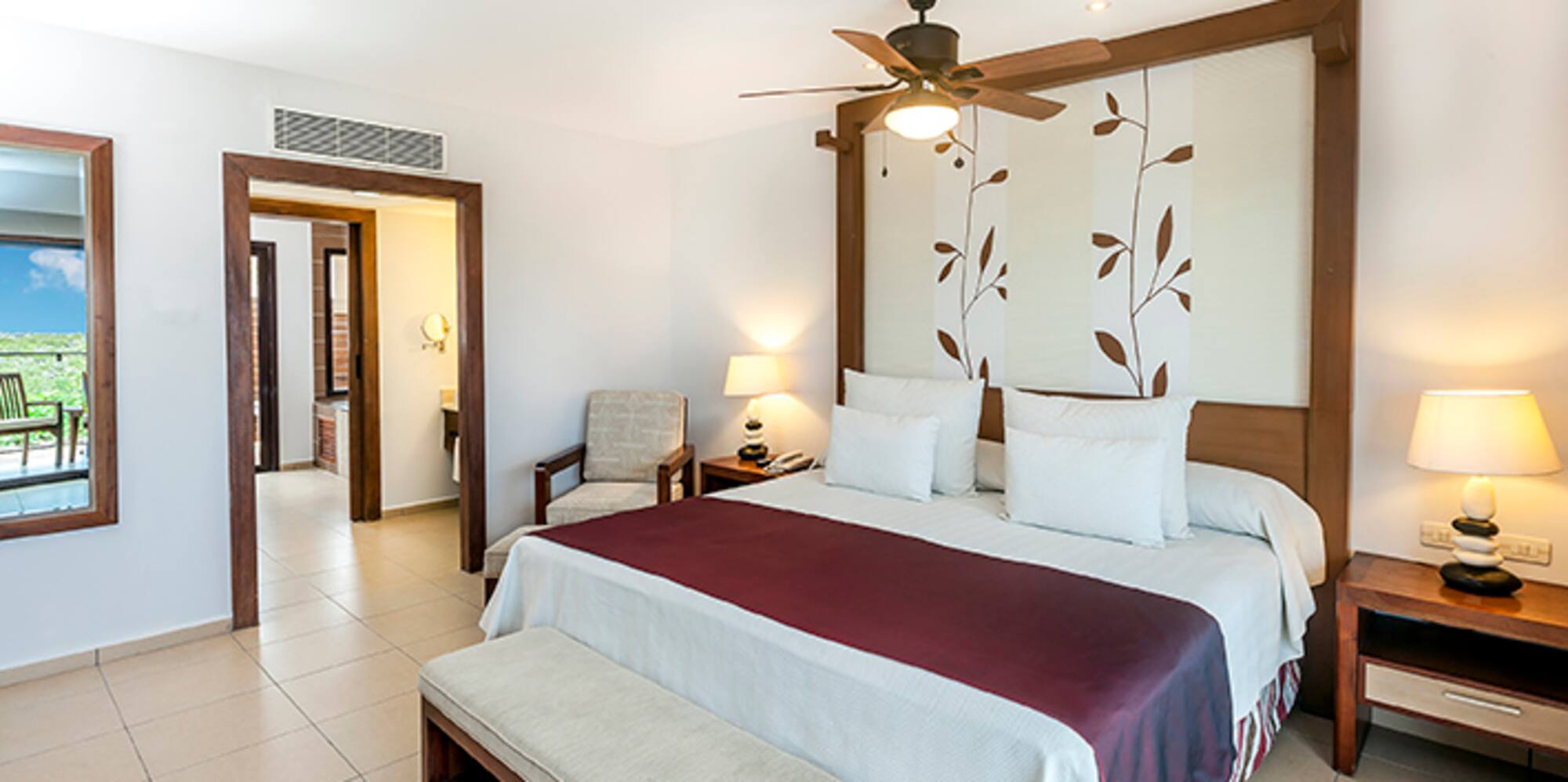 a bedroom with a bed and a fan