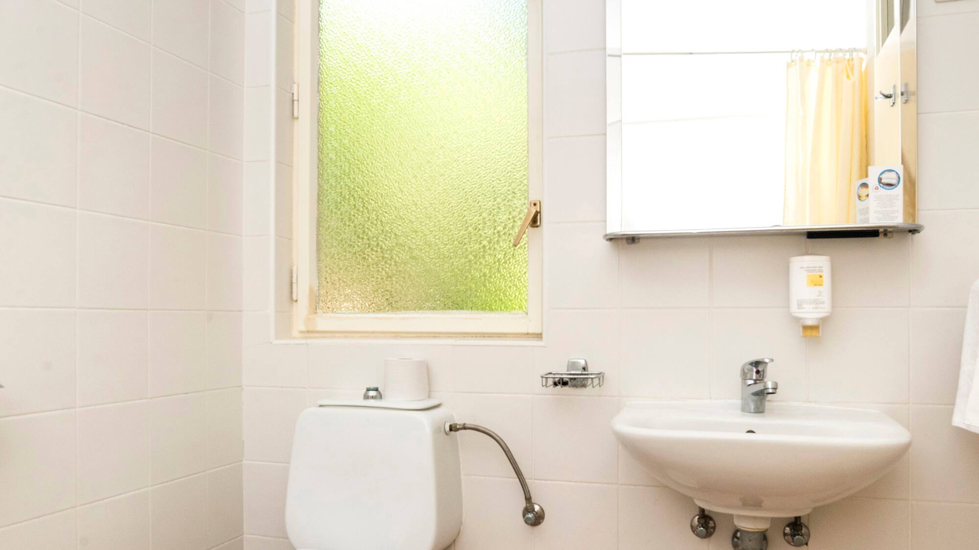 a bathroom with a mirror and toilet
