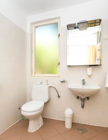 a bathroom with a mirror and toilet