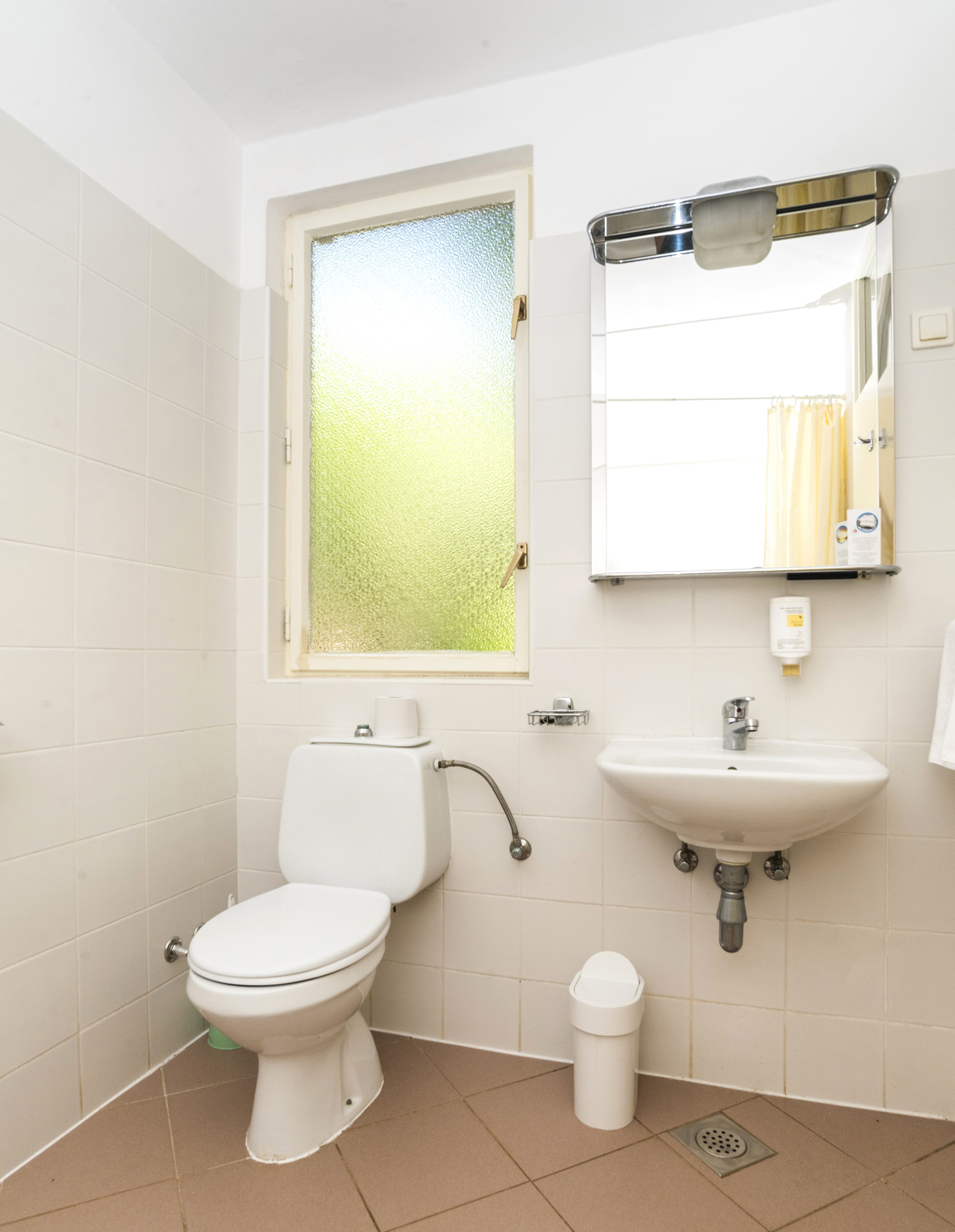 a bathroom with a mirror and toilet