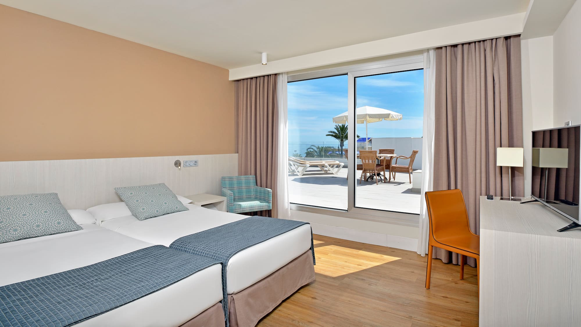 a hotel room with a large window and chairs