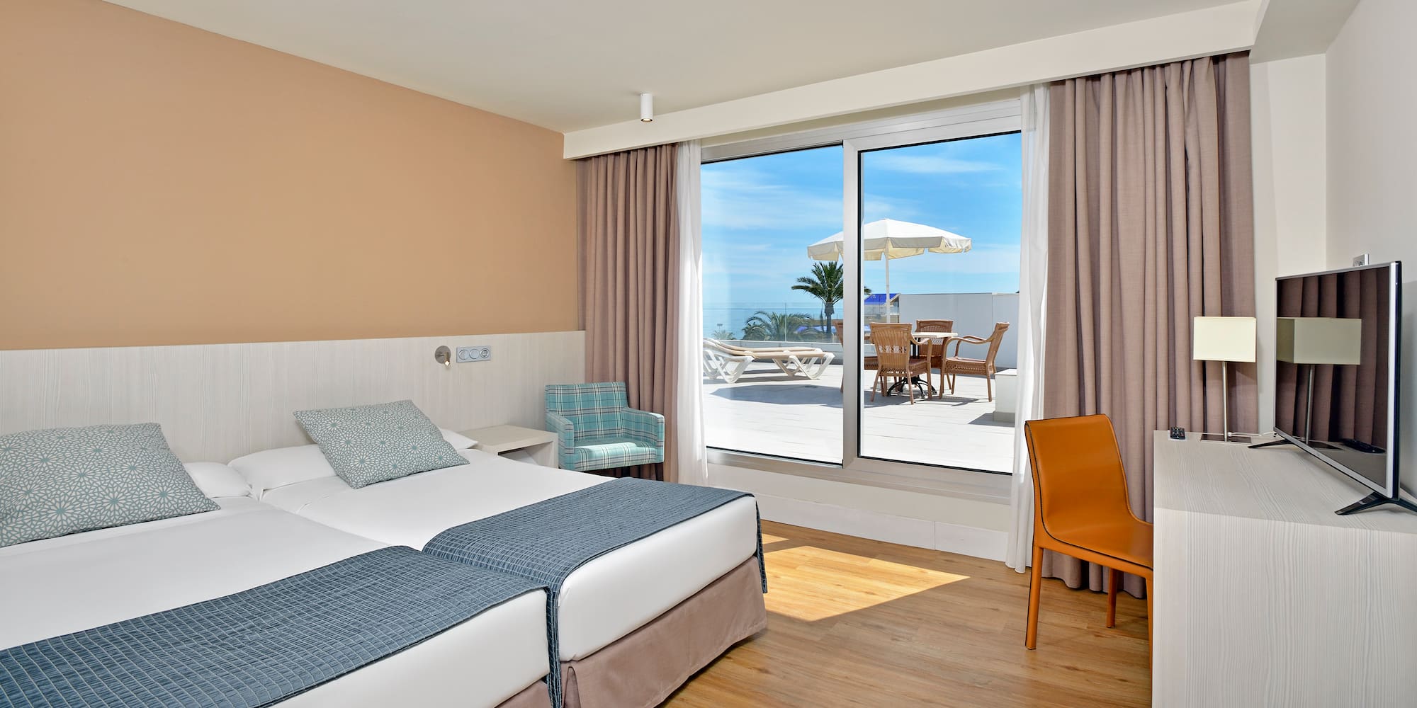 a hotel room with a large window and chairs