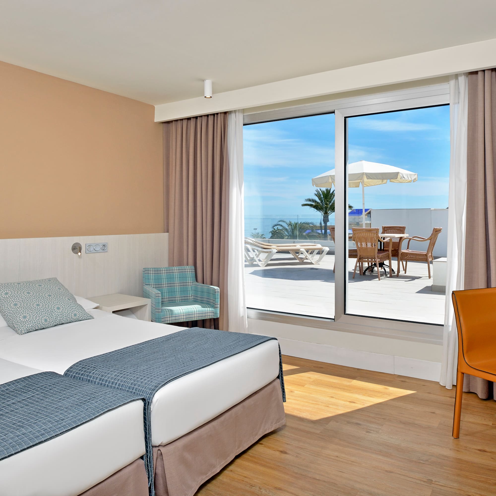 a hotel room with a large window and chairs