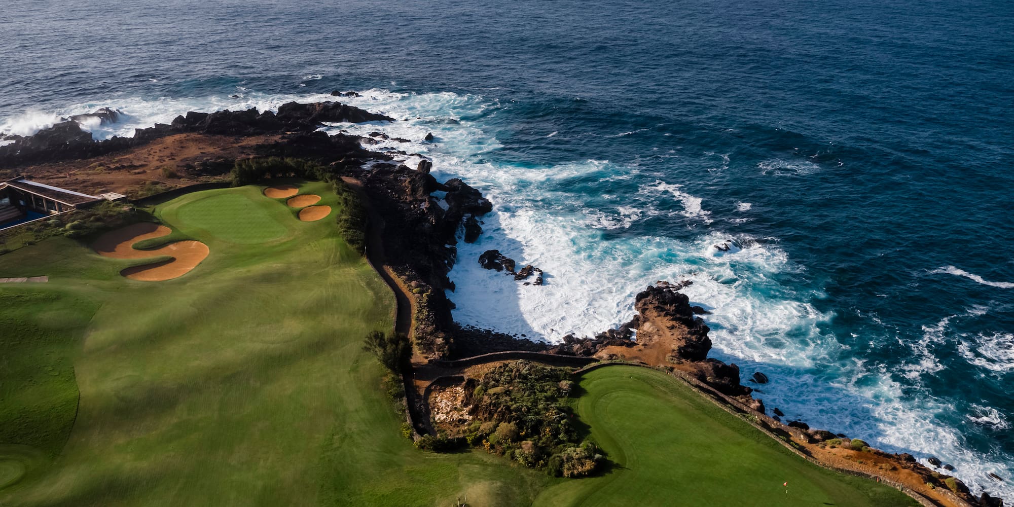 a golf course with a body of water