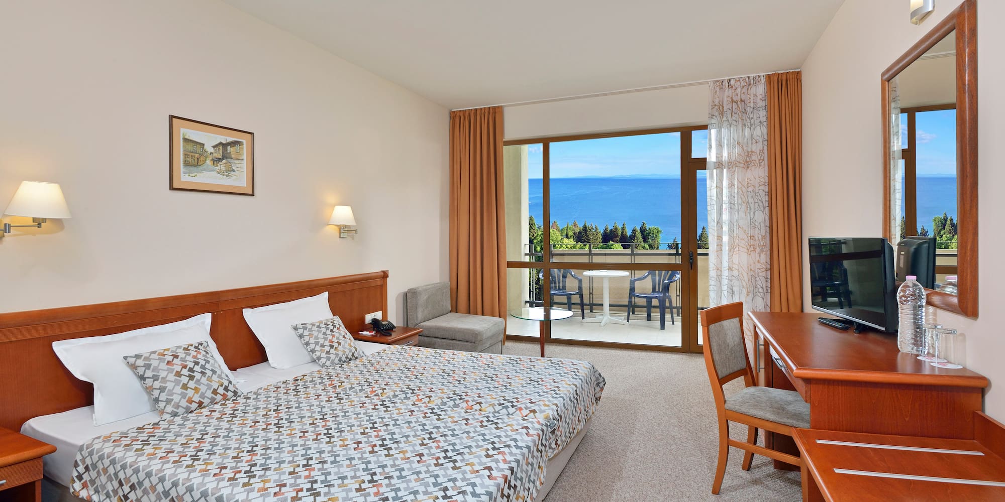 a bedroom with a bed and a table and chairs