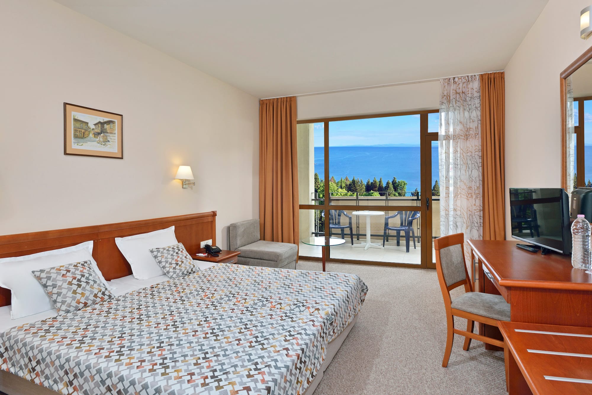 a bedroom with a bed and a table and chairs