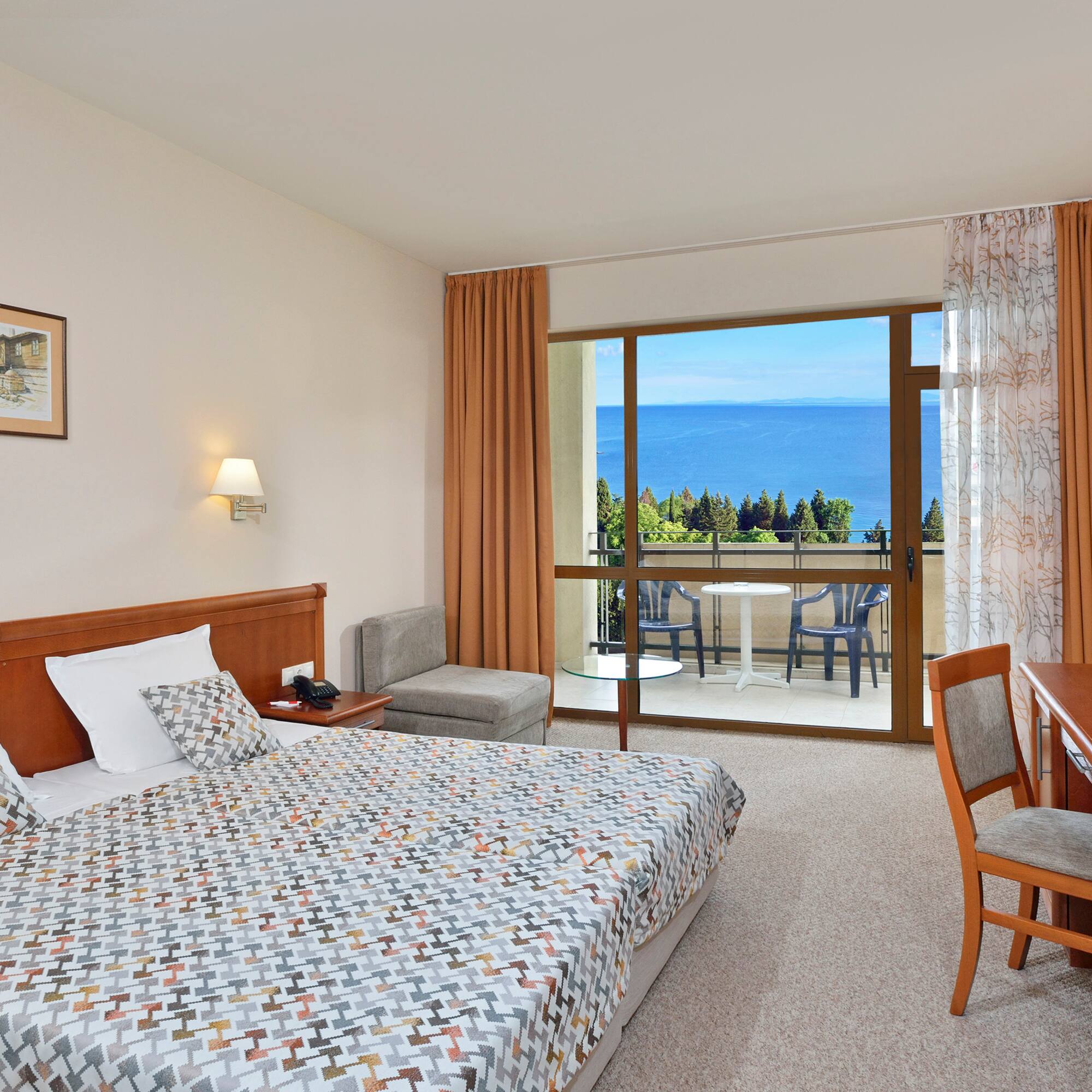 a bedroom with a bed and a table and chairs