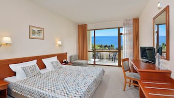 a bedroom with a bed and a table and chairs