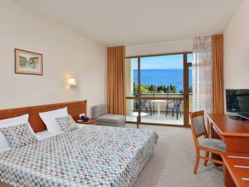 a bedroom with a bed and a table and chairs