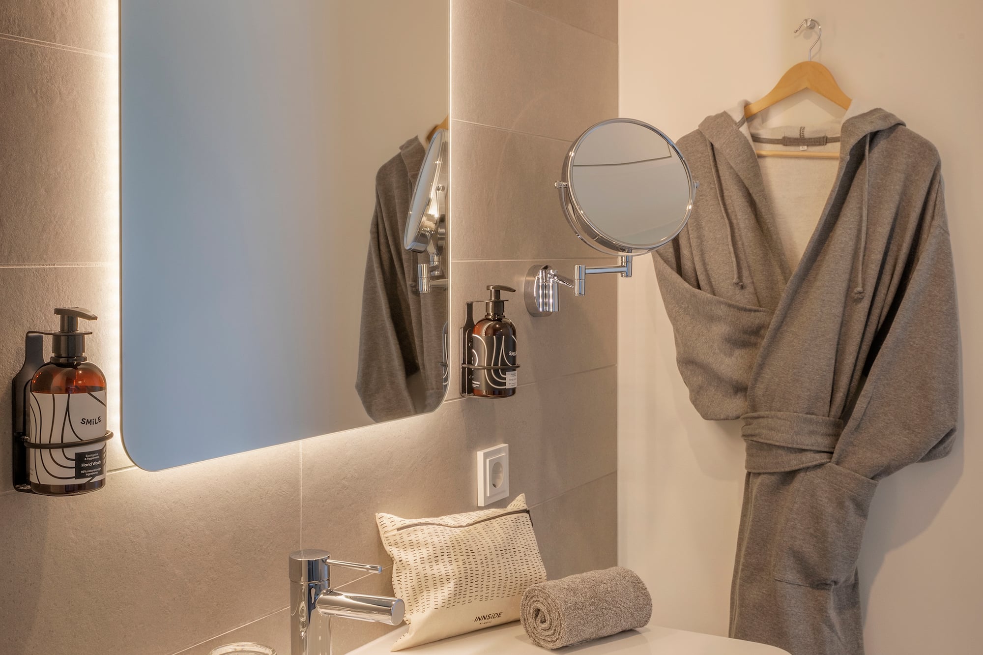 a bathroom with a bathrobe and a mirror