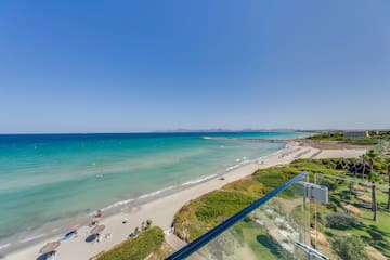 a beach with a clear glass railing