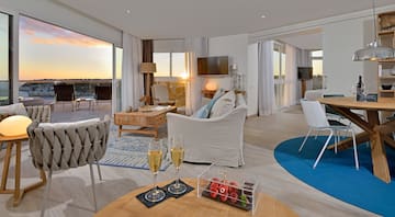 a room with a couch and a table with wine glasses