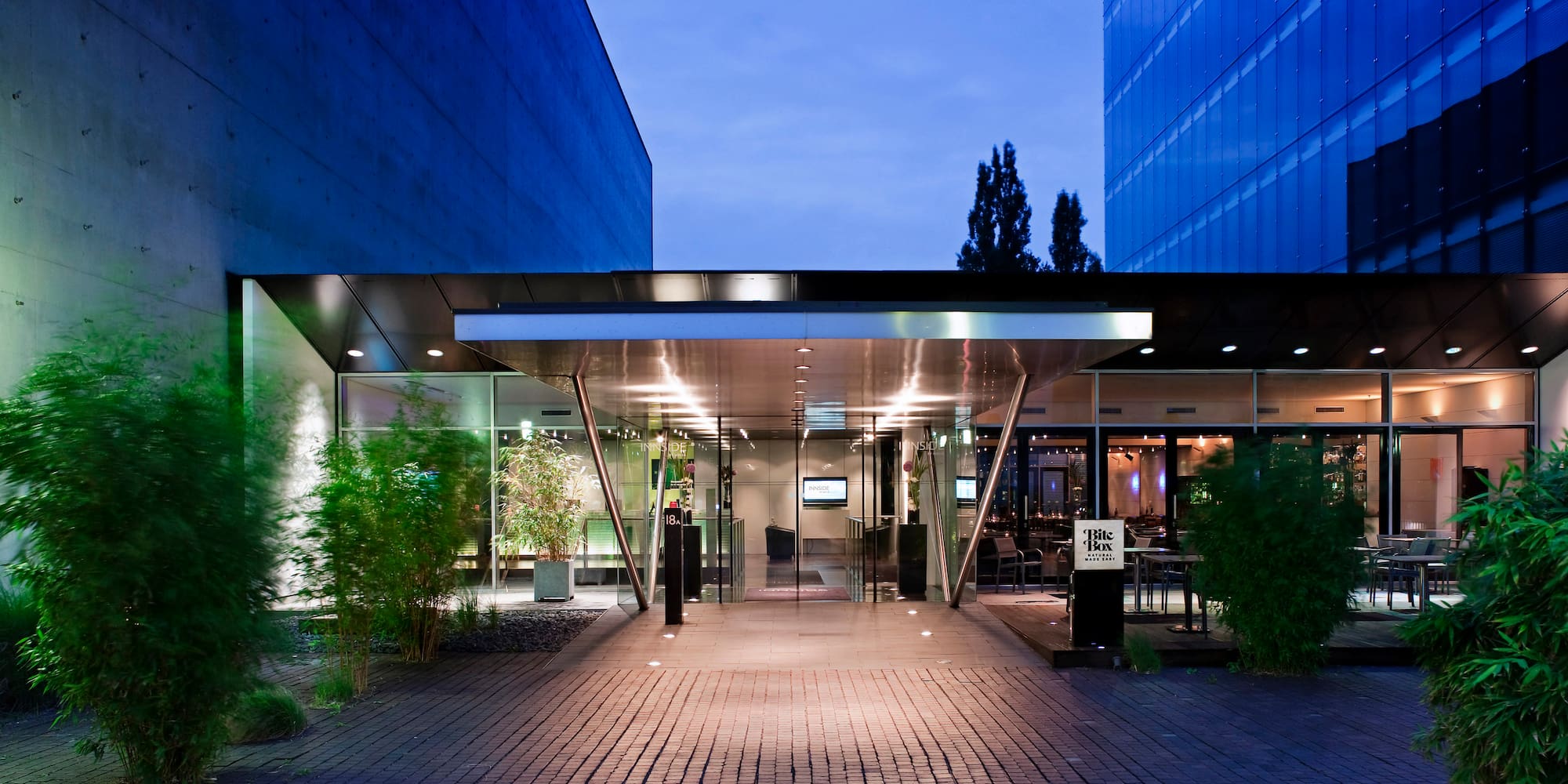 a building with glass doors and a brick walkway